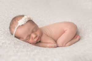 newborn babies on cream with floral headband